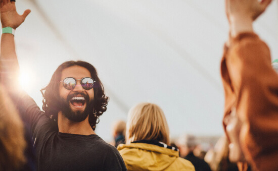 Man celebrating at a festival. With a YouChoose account you can afford to celebrate with interest earned and an overdraft facility.