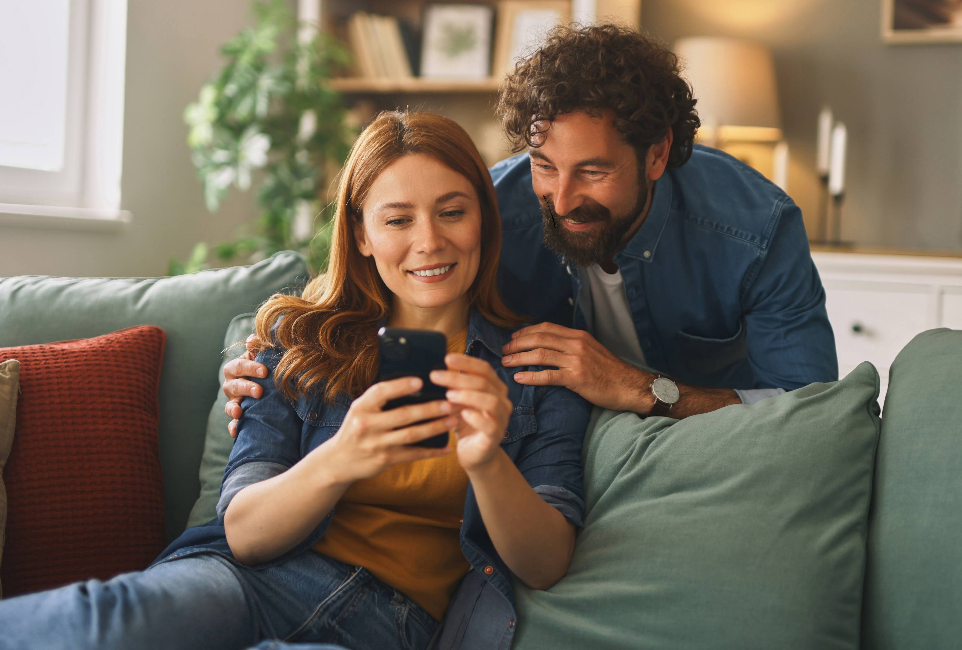 A couple review their Heartland savings and deposit acounts online